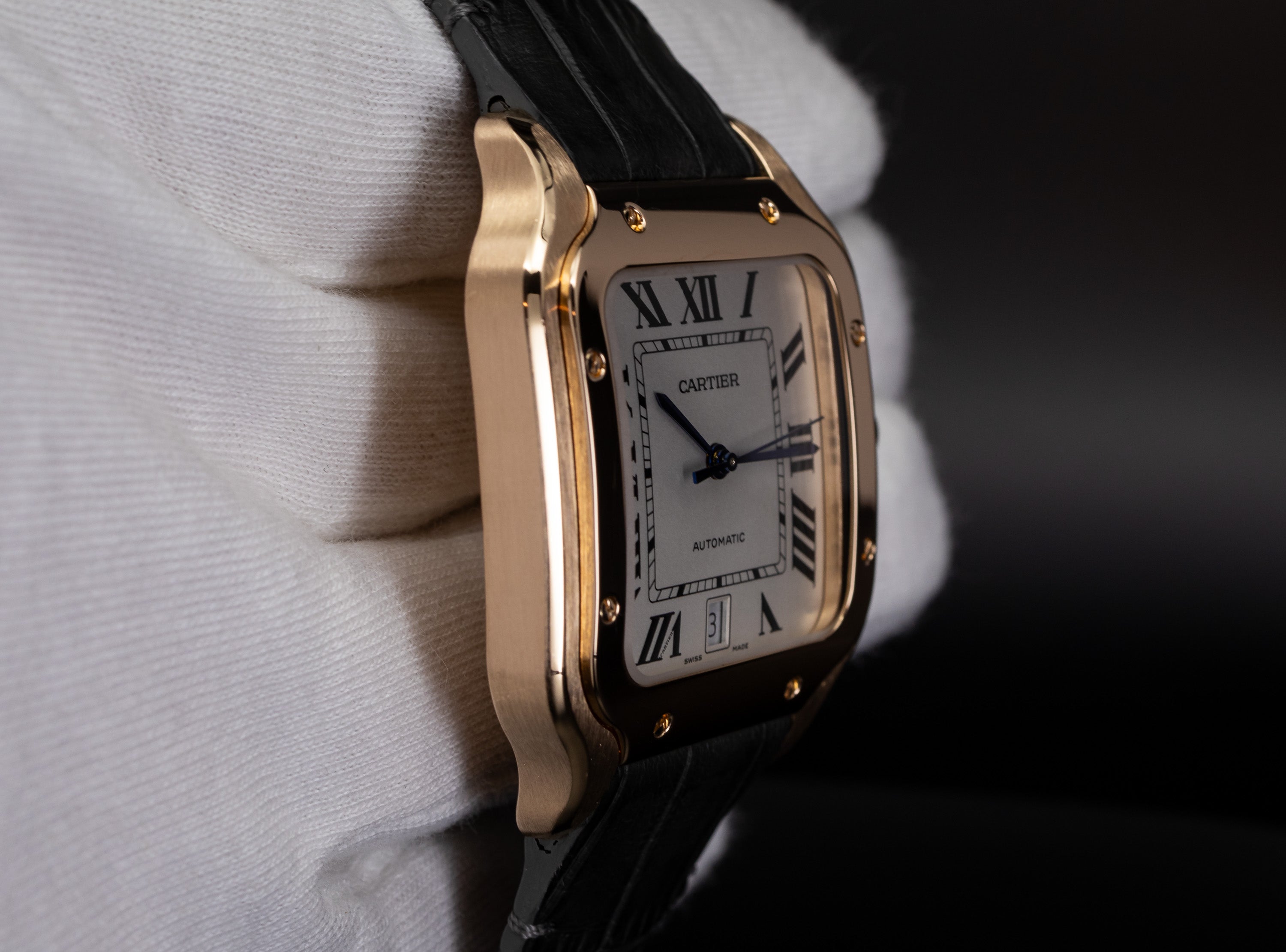 Cartier Santos de Cartier 18K Rose Gold in white gloved hand WGSA0011