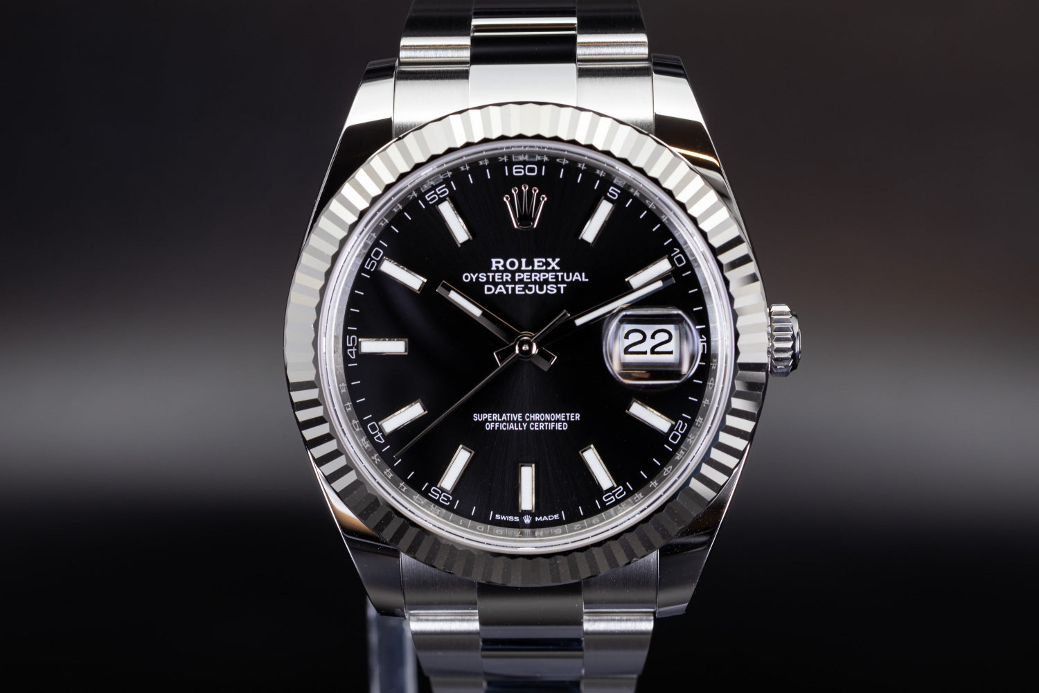 Rolex Datejust 41 126334 with fluted bezel, black sunburst dial, and luminous baton markers