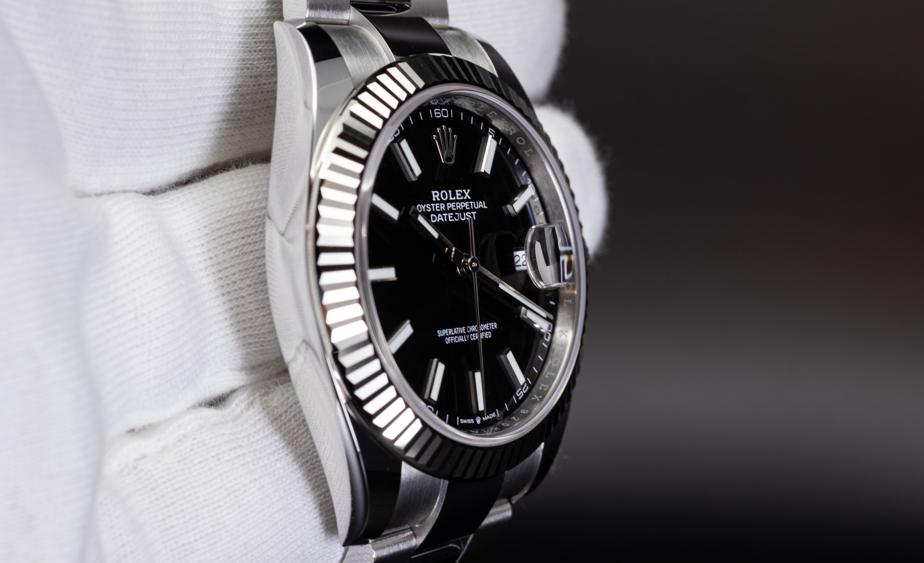 Rolex Datejust 41 126334 with fluted bezel, black dial, and polished stainless steel case
