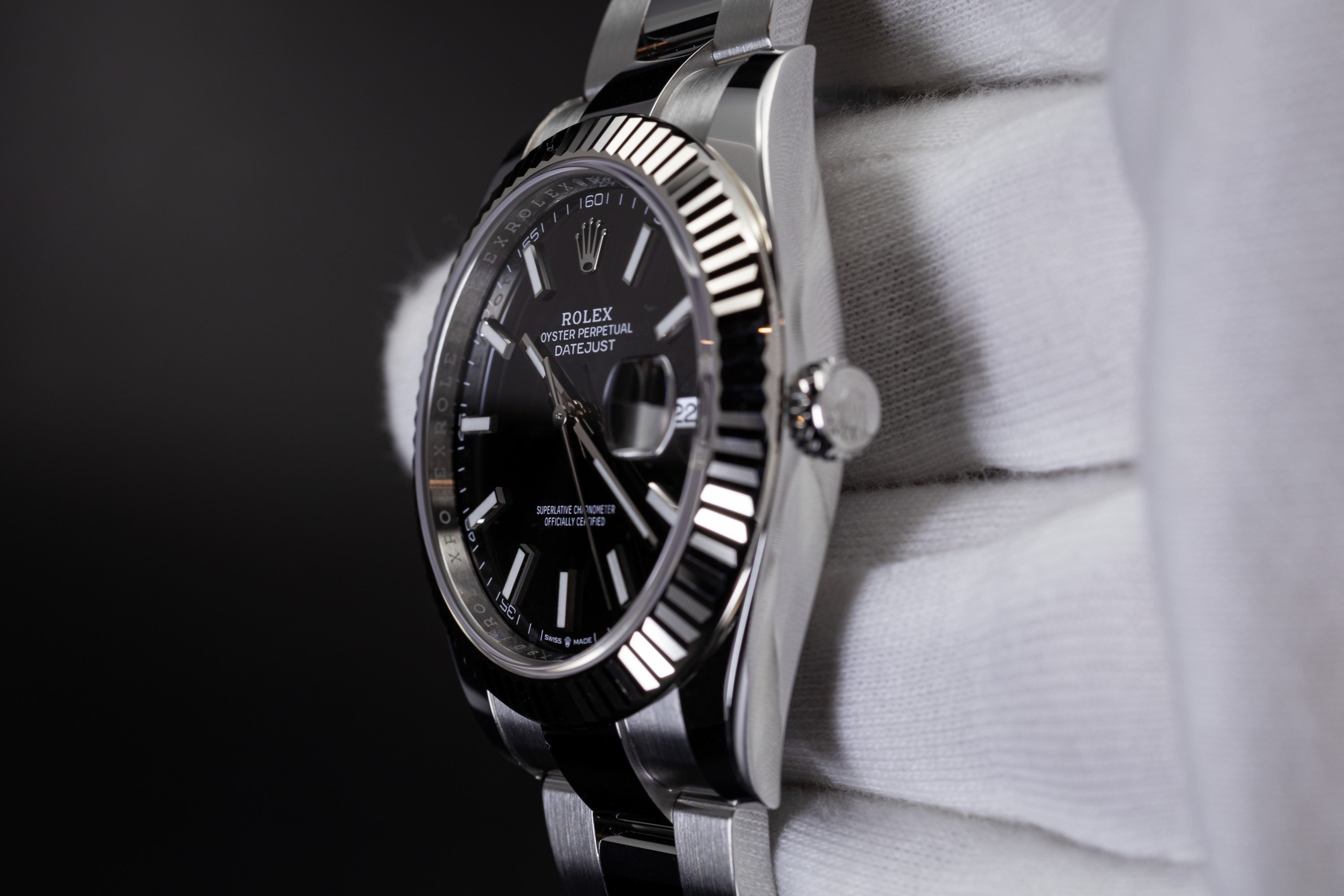 Rolex Datejust 41 126334 with fluted bezel, black dial, and screw-down crown
