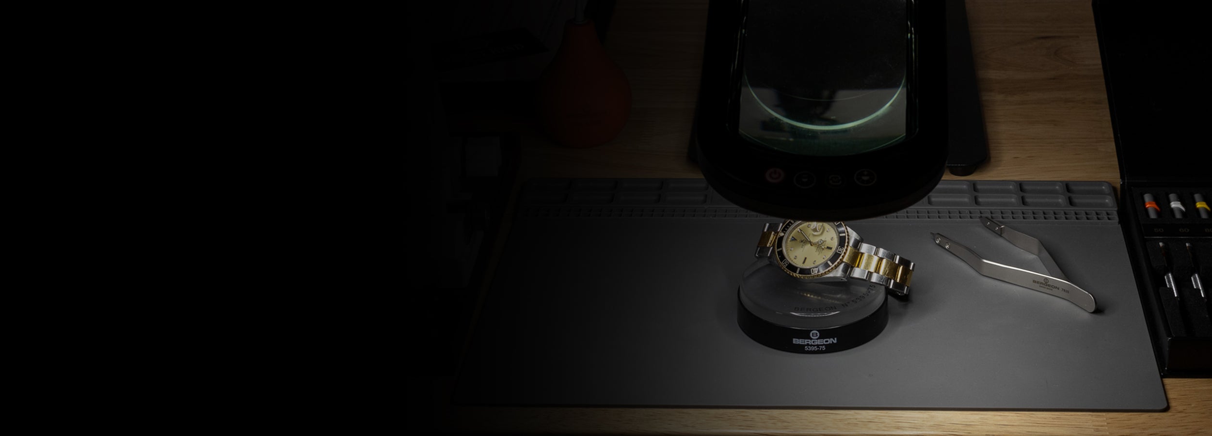 Luxury watch verification workspace with inspection tools and diagnostics equipment