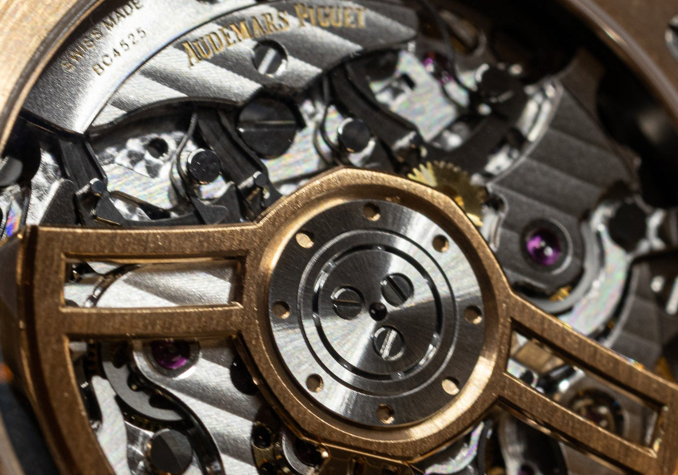 close up of mechanical watch movement in Audemars Piguet Royal Oak Chronograph featuring rose gold rotor wheel
