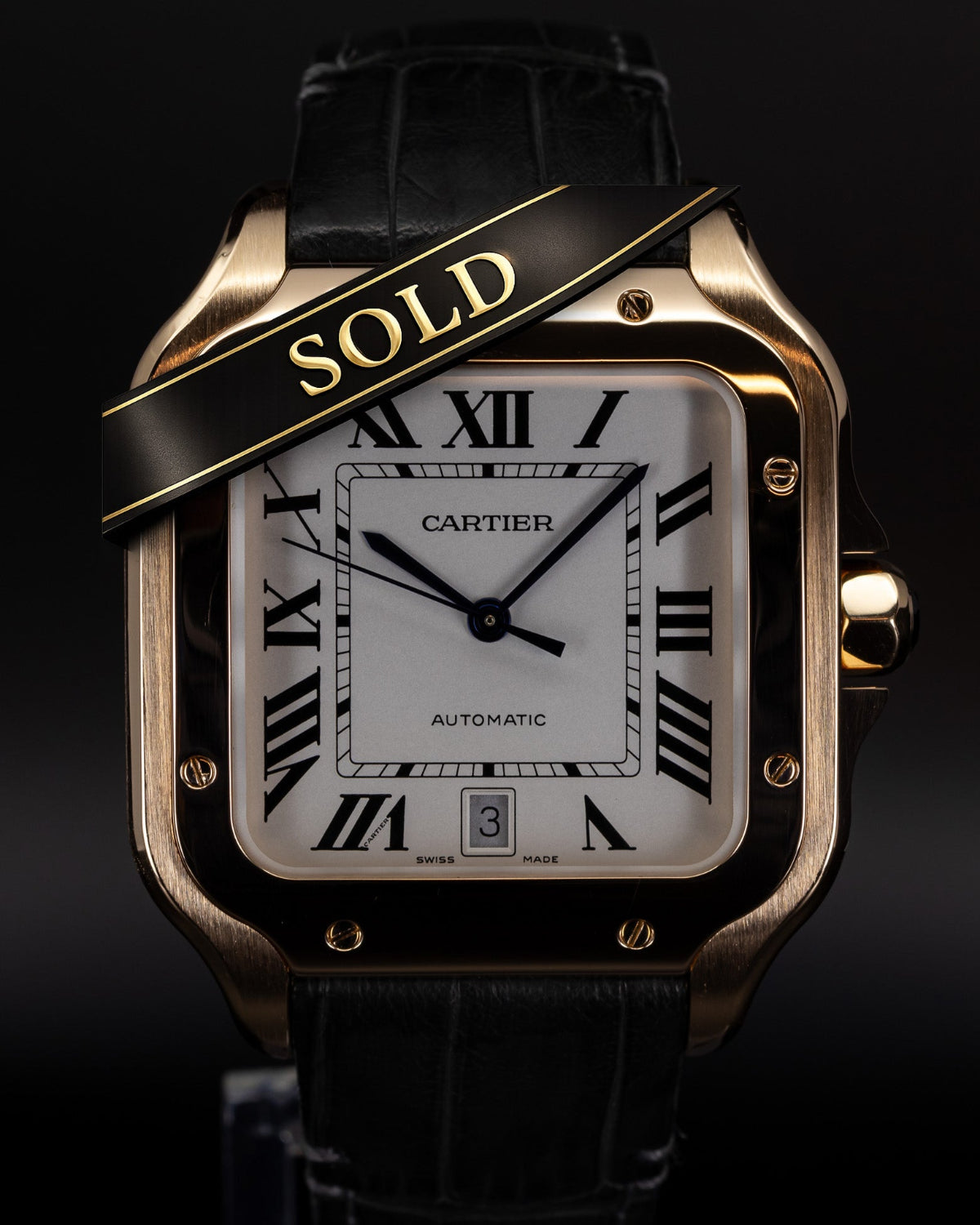 Cartier watch with 'SOLD' label on a black background
