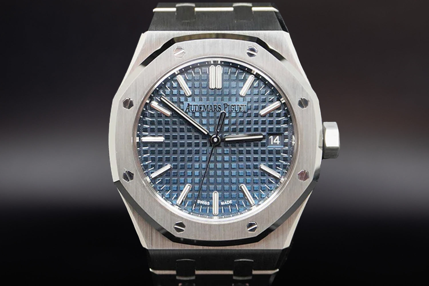 Audemars Piguet Royal Oak luxury sports watch with blue tapisserie dial and stainless steel bracelet