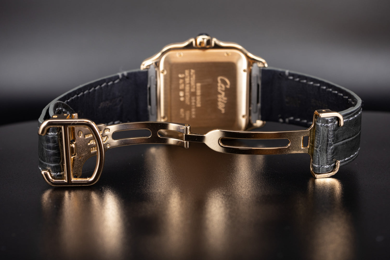 Rose Gold Cartier deployant clasp on a black alligator leather strap