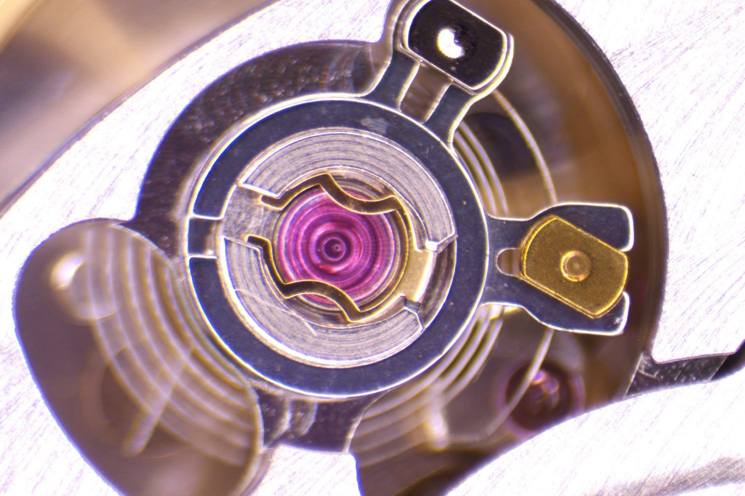macro image of the Cartier Cal. 1847 MC mechanical luxury watch movement regulator and shock absorber.