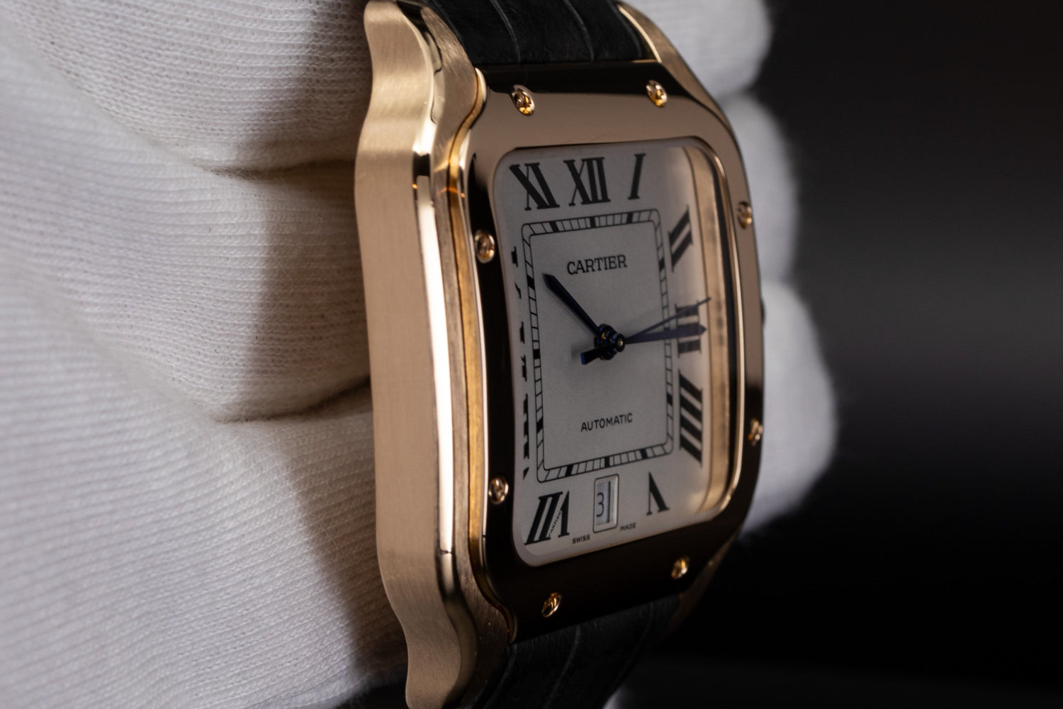 Rose Gold Cartier Santos de Cartier case and bezel details with white gloved hand