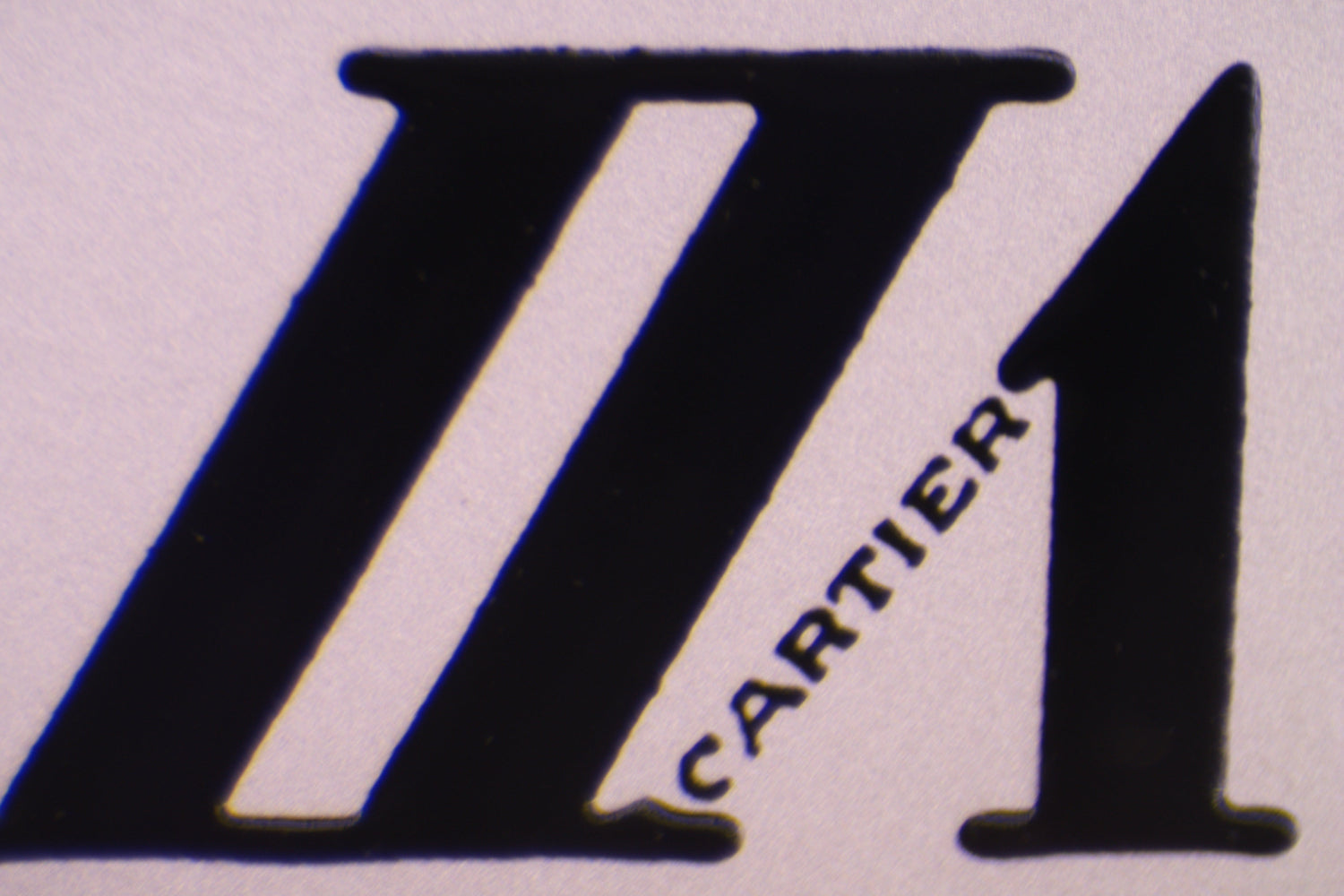 macro close-up image of the secret Cartier logo in the roman numeral VII