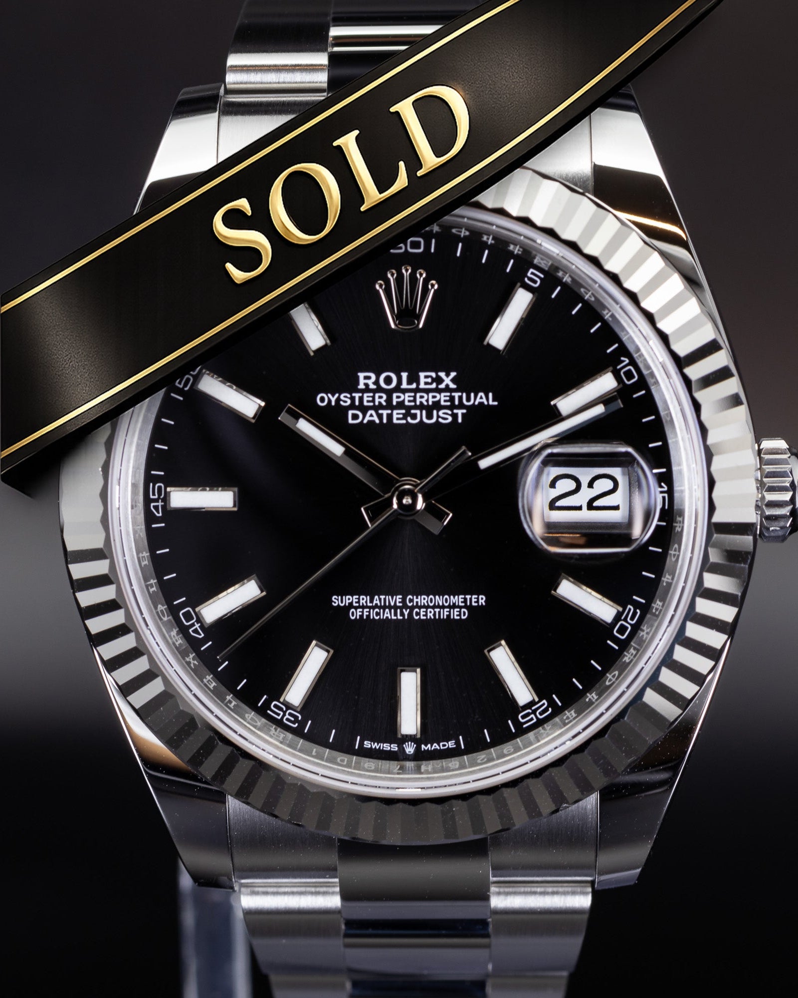 Rolex Datejust luxury watch with black dial and fluted bezel on oyster bracelet